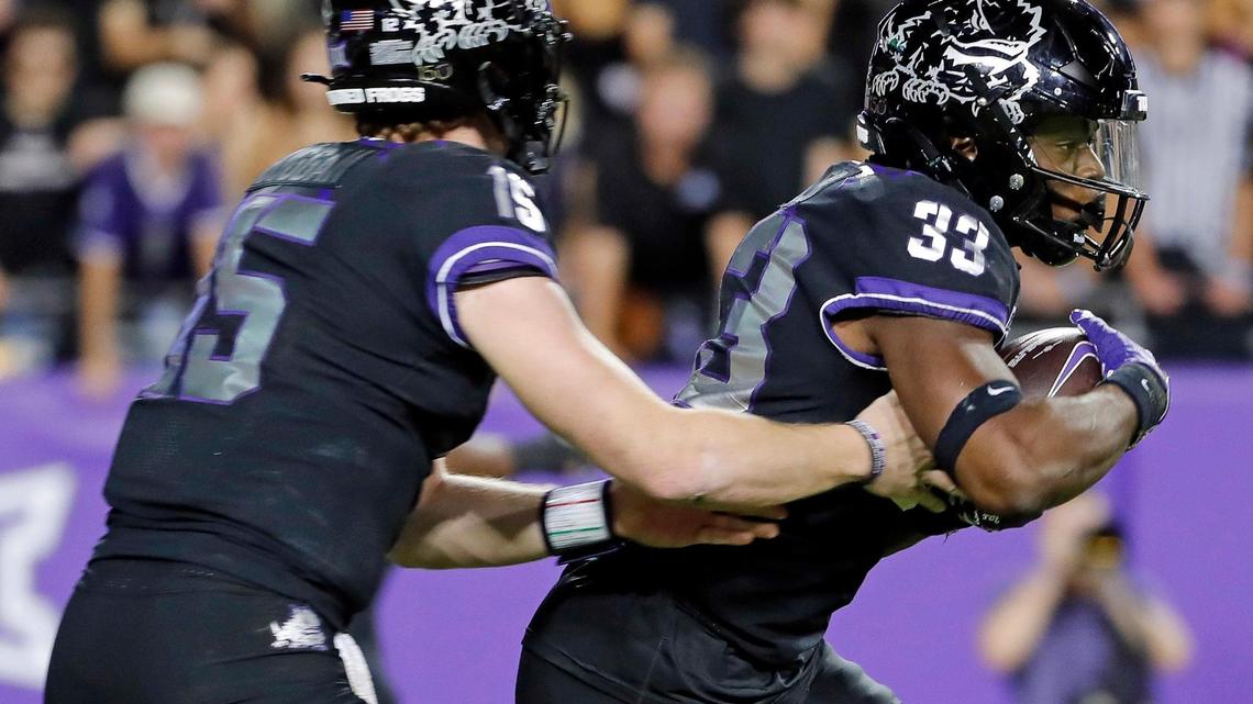TCU quarterback Max Duggan (15) hands the ball to running back Kendre Miller (33) in the first half of a NCAA football game at Amon G. Carter Stadium in Fort Worth, Texas, Saturday, Oct. 22, 2022. Kansas State led TCU 28-17 at the half. (Special to the Star-Telegram Bob Booth)