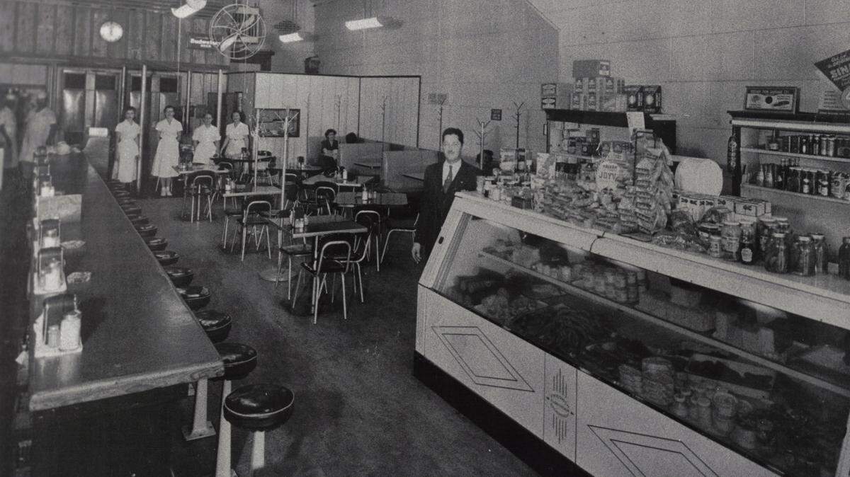 The interior of Carshon’s deli at 1010 Houston St. in 1951 shows owner Abe Applebaum near the deli counter, which is stocked on top with his wife’s homemade dill pickles and with halva, a middle eastern sweet. In the background, wearing white uniforms, are two butchers and four waitresses.