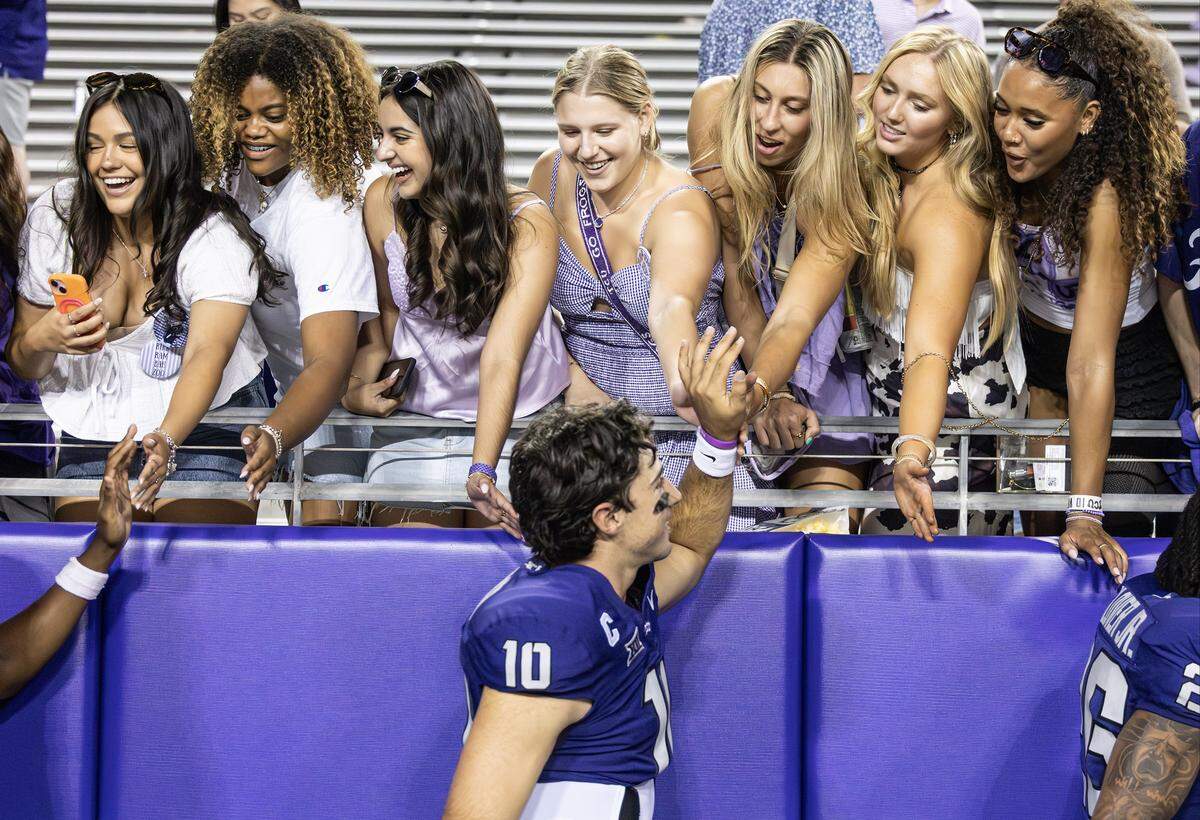 TCU quarterback Josh Hoover high fives TCU fans after an NCAA game between TCU and Abilene Christian at Amon G. Carter Stadium in Fort Worth on Saturday, Sept. 13, 2025.