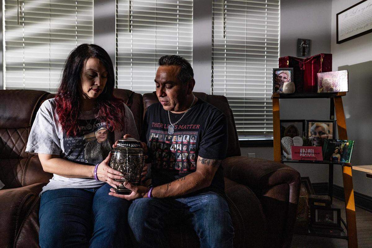 Adolph and Peggy Alvarez hold the urn of their daughter Abigil, who died from a fentanyl overdose on May 14, 2022, at 18 years of age, at their apartment in Fort Worth on Thursday, Aug. 17, 2023. Adolph and Peggy said Abigil was in a room full of people when she overdosed, but was left unconscious for around 11 hours before being found by authorities.