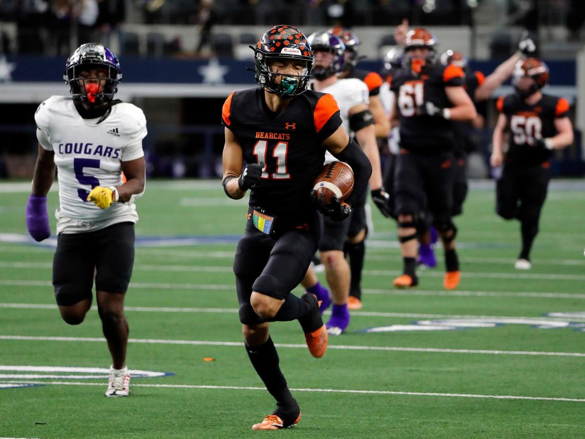 Aledo wide receiver Jalen Pope (11) leads everyone to the end zone for a touchdown in the first half of a UIL Class 5A D1 state championship football game at AT&T Stadium in Arlington, Texas, Saturday, Dec. 16, 2022. Aledo led 35-0 at the half. (Star-Telegram Bob Booth)