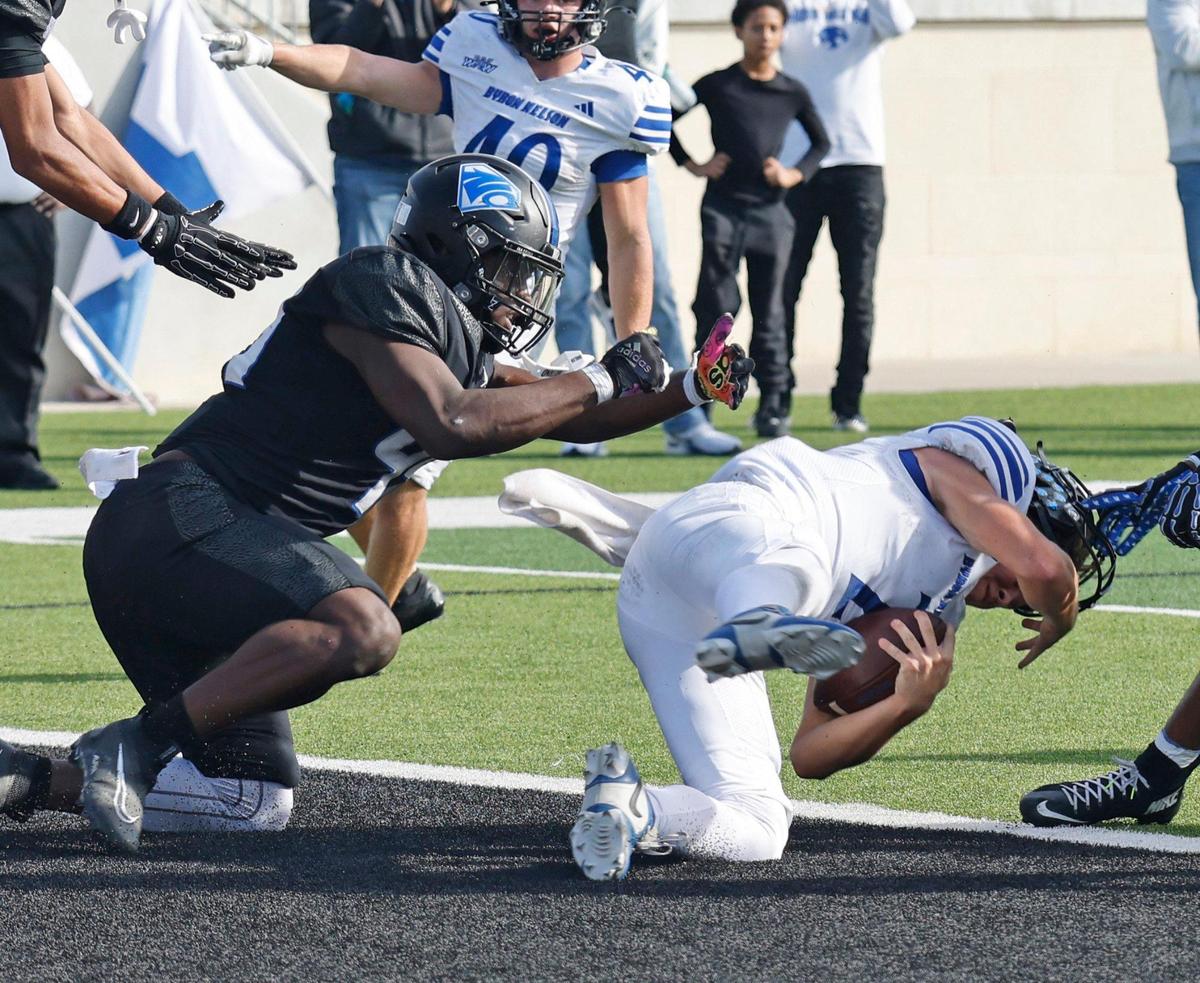 Byron Nelson quarterback Grant Bizjack (2) has his helmet ripped off as he goes in to tie the game before the half during a UIL Class 6A D1 Bi-district playoff football game at Crowley ISD Multi-Purpose Stadium in Fort Worth, Texas, Saturday, Nov. 16, 2024.