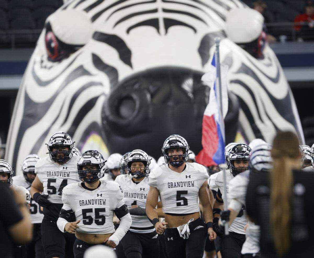 The Grandview Zebras take the field against Yoakum Bulldogs during the first half of a UIL Class 3A Division I championship game on Thursday Dec. 18, 2025 at AT&T Stadium in Arlington, Texas.