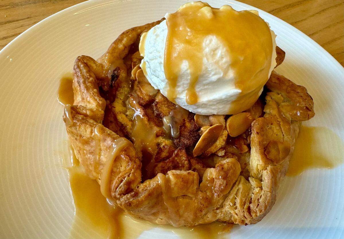 An apple almond tart with whipped cream at Taste Project’s community restaurant Feb. 17, 2024.