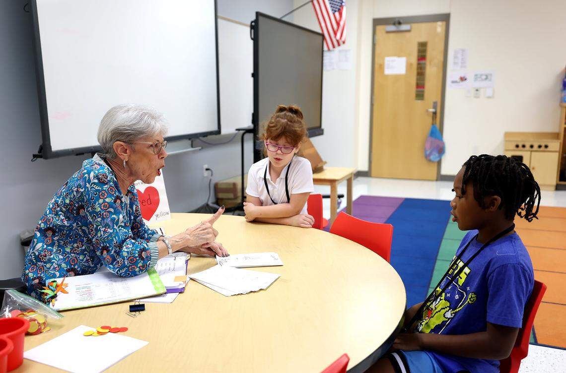 Retired teacher Martha Farr, left, tutors second graders Gabriela Ringnald, center, Malachi Murkledove in reading at Westpark Elementary School on Thursday, Sept. 19, 2025. 
