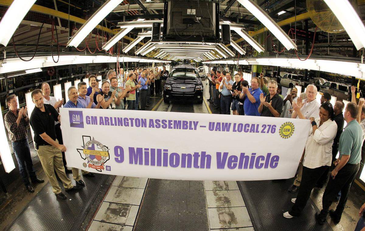 May 11, 2011: GM employees begin to applaud as the 9 millionth vehicle rolls down the final inspection line towards a banner created to mark the event at the Arlington Assembly plant. The vehicle, a black “Texas Edition” Suburban SUV, will be used by GM as a show vehicle.