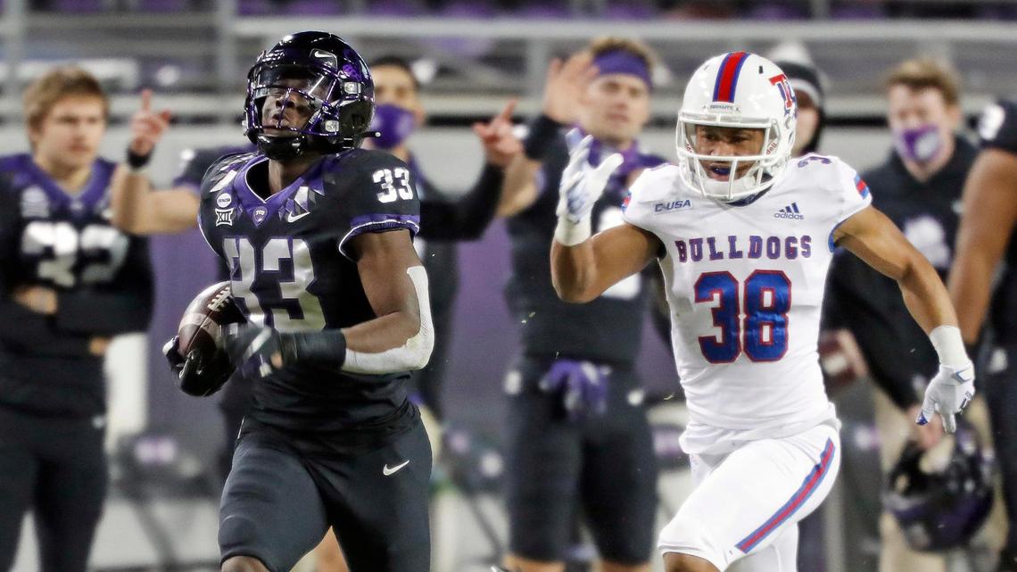 TCU running back Kendre Miller (33) outruns Louisiana Tech defensive back Charvis Thornton (38) to the end zone for the final score of the game during the second half of a NCAA football game at Amon G. Carter Stadium in Fort Worth, Texas, Saturday, Dec. 12, 2020. TCU defeated Louisiana Tech 52-10. (Special to the Star-Telegram Bob Booth)