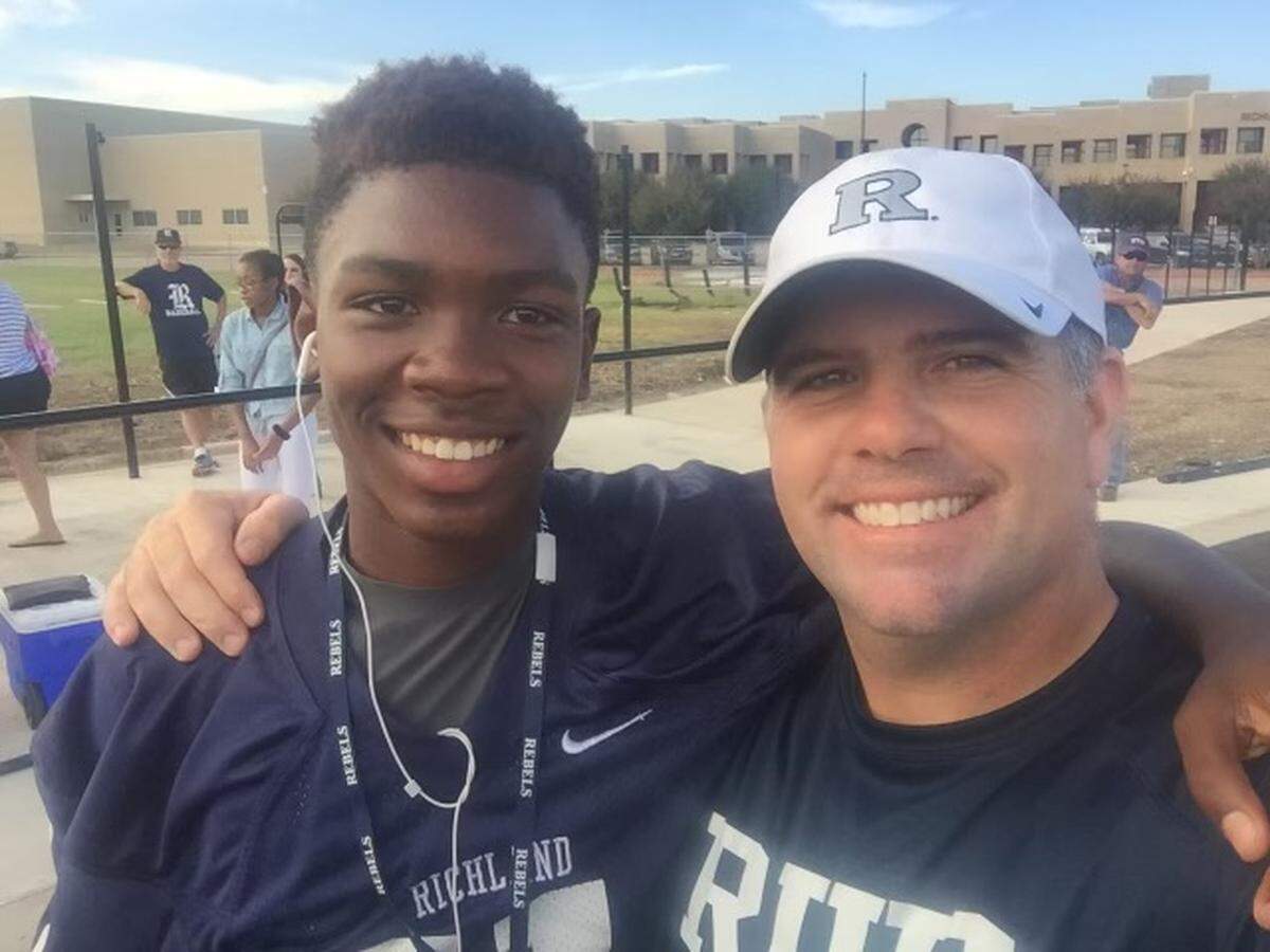 Rashee Rice, in his freshman year at Richland High School, takes a photo with Richland football head coach Ged Kates.