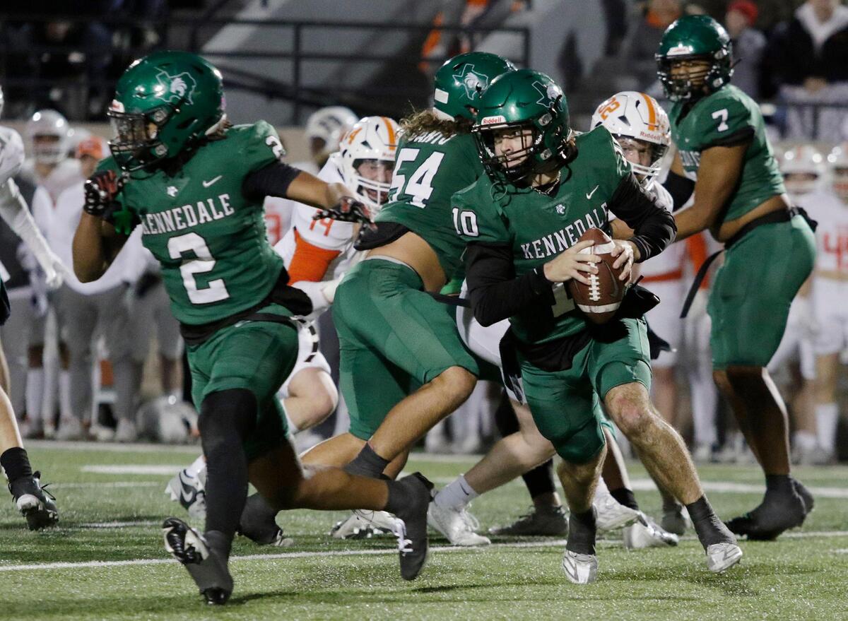 Kennedale’s Jackson Hammonds rolls out to pass during a UIL football playoff game at Pennington Field on Friday November 22, 2024.