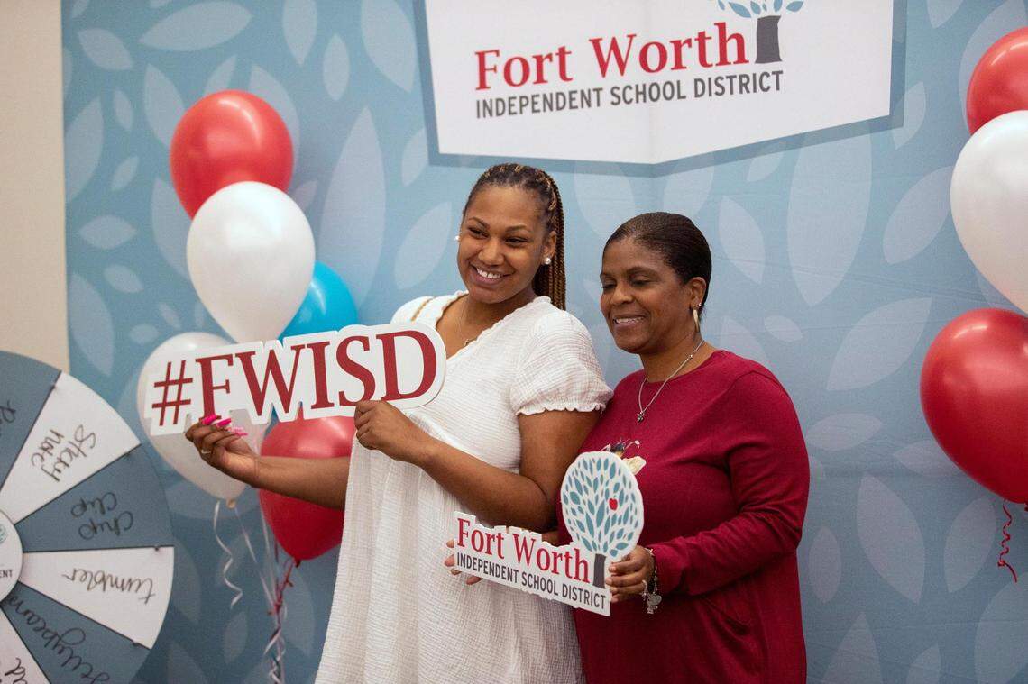 New teacher Shaquila Anderson poses with a school administrator after accepting a new position at Bill J. Elliott Elementary School during the Fort Worth Independent School District Summer Mega Career Fair on June 7, 2022, at the FWISD Teaching & Learning Center.