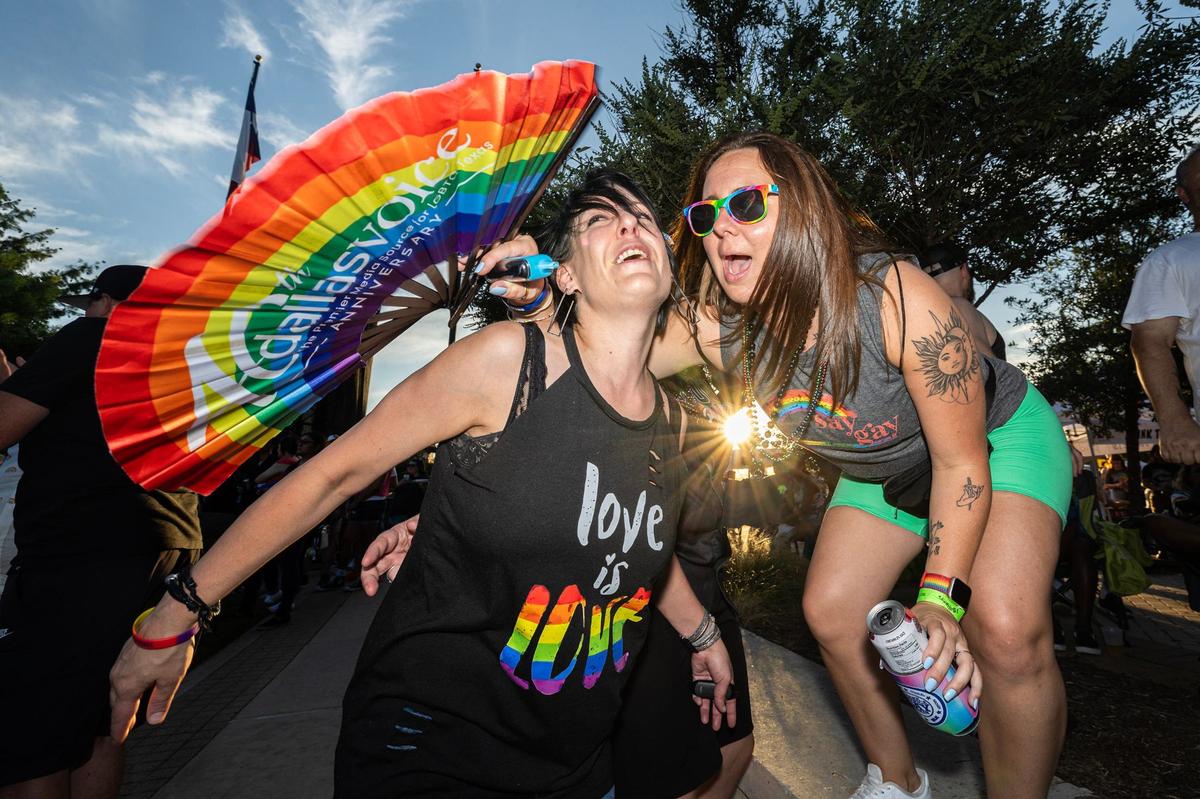 Rebecca Carr, left, and Reagan Rios dance together to “I Wanna Dance with Somebody,” performed by Kameron Ross on stage at the Arlington Pride event at Levitt Pavilion in Arlington on Saturday, June 8, 2024.