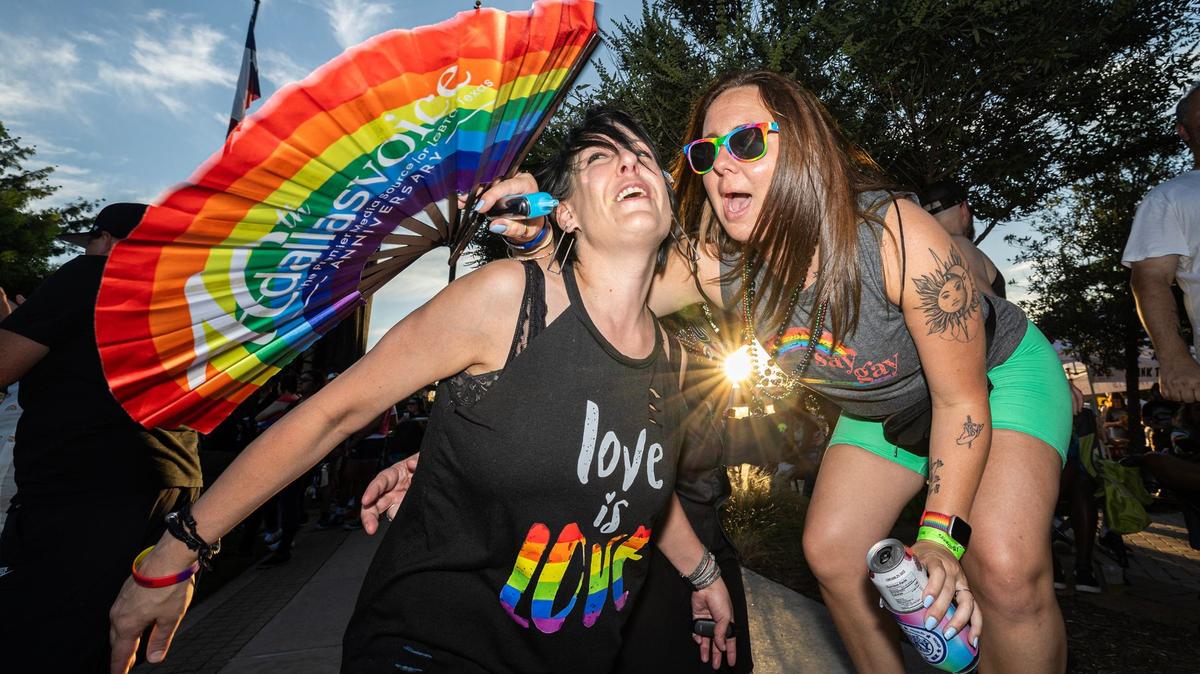 Rebecca Carr, left, and Reagan Rios dance together to “I Wanna Dance with Somebody,” performed by Kameron Ross on stage at the Arlington Pride event at Levitt Pavilion in Arlington on Saturday, June 8, 2024.