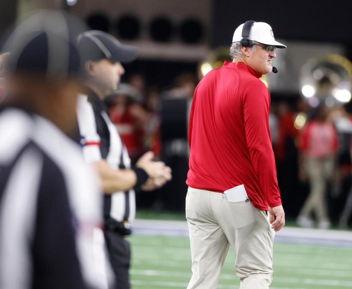 Columbus head coach Matt Schobel glances back to the field with a minute remaining in the half during the UIL 3A D1 State Championship football game at AT&T Stadium in Arlington, Texas, Thursday, Dec. 19, 2024.