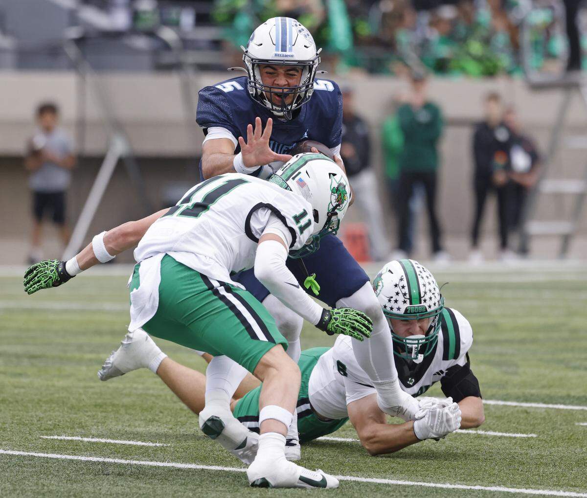 L.D. Bell quarterback Braelon Harris (5) braces for the hit from Southlake defensive back Taevin Kunz (11) during the first half of a UIL football game between Carroll and L.D. Bell at Pennington Field in Bedford, Texas, Friday, October, 24, 2025.