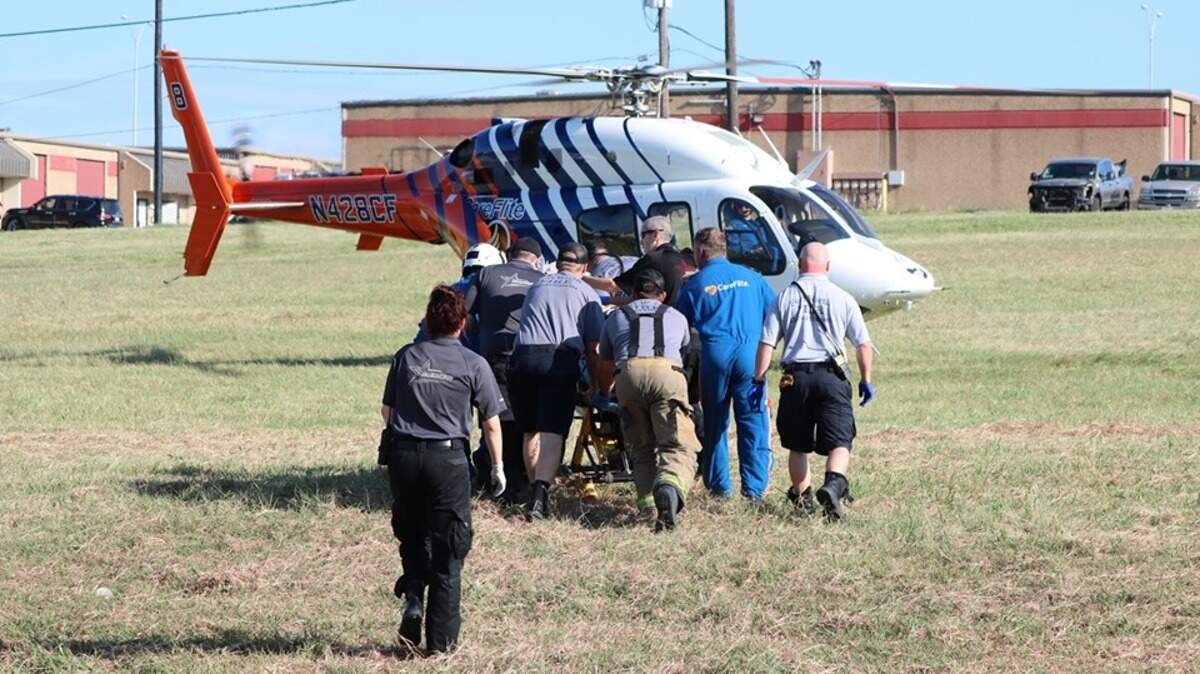 Fort Worth firefighters and other responders transport a man with respiratory burns to a helicopter to be taken to a local hospital. It’s unclear how the man became burned, according to Mike Drivdahl, a fire department spokesman.