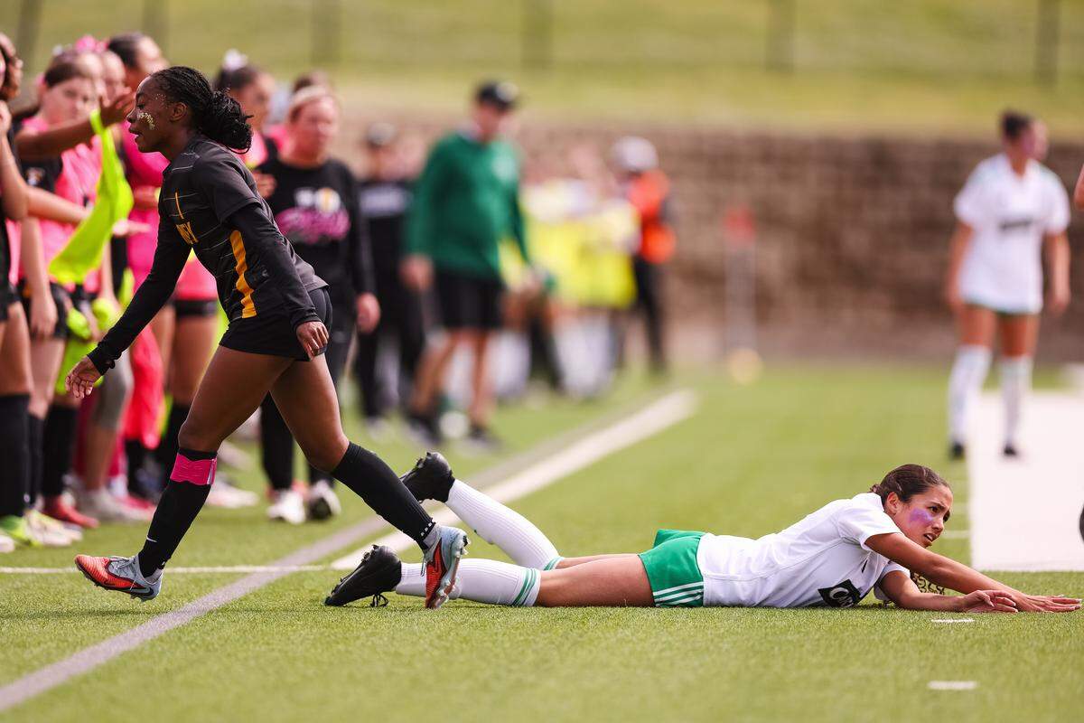 Southlake Carroll striker Mariana Auns (23) lies on the ground after a play against Forney in a UIL Class 6A Division 2 girls soccer state semifinal on Saturday, April 4, 2026, at Memorial Stadium in Mesquite, Texas.