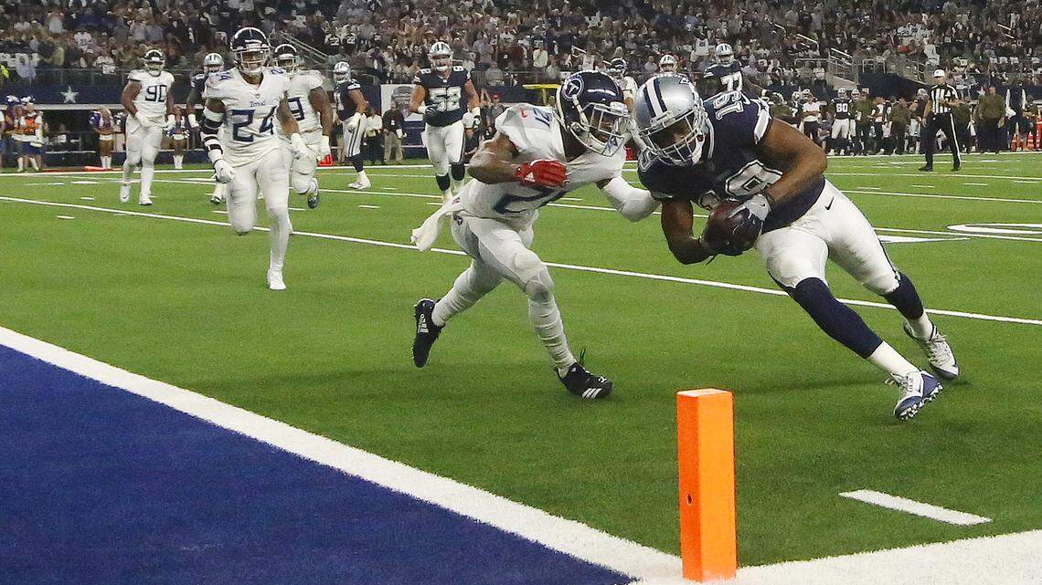 Dallas Cowboys wide receiver Amari Cooper scores his first touchdown since being traded from the Oakland raiders against Tennessee Titans cornerback Malcolm Butler in the first quarter Monday night at AT&T Stadium.