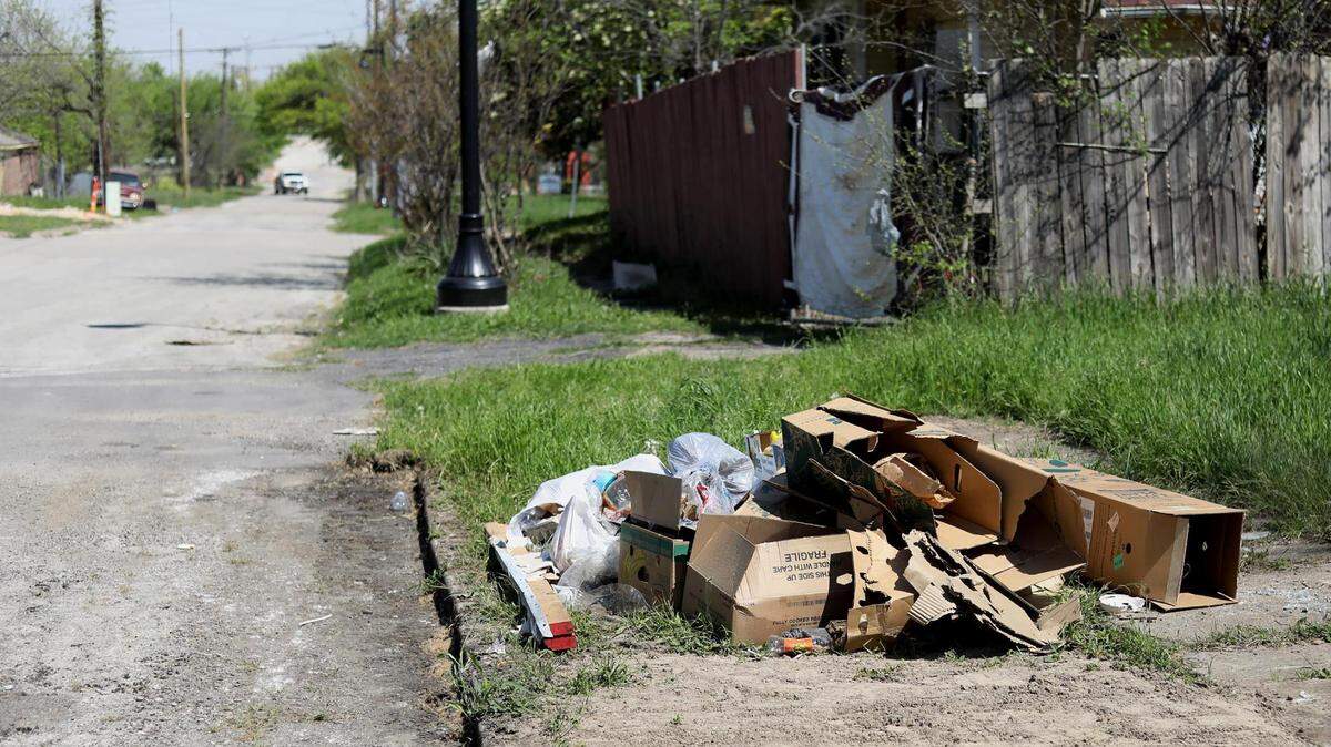 Trash sits on a lot in the Historic Southside neighborhood on April 1, 2021.
