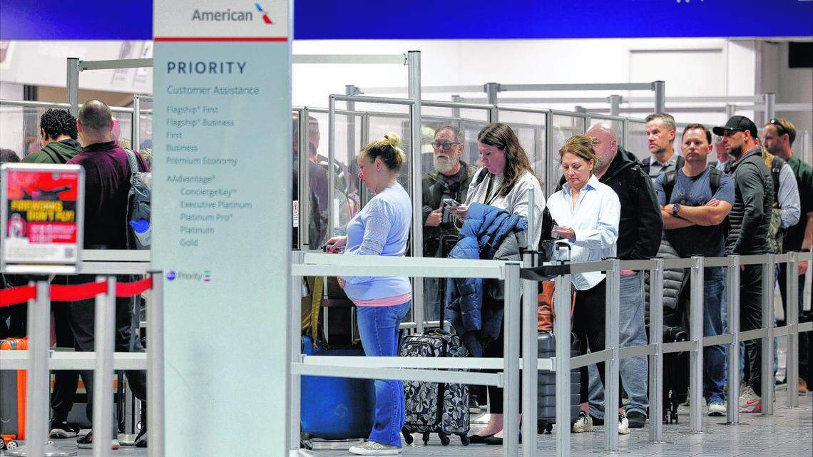 Passengers wait in line at a TSA security checkpoint inside Terminal C at DFW International Airport on March 1, 2023.