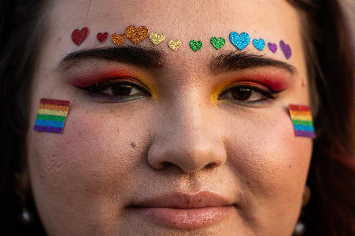 Mallory Pradhan wears pride stickers on her face for the Arlington Pride event at Levitt Pavilion in Arlington on Saturday, June 8, 2024.