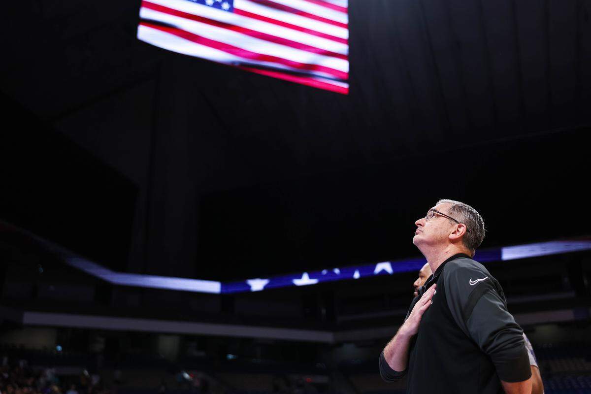 North Crowley head coach Tommy Brakel holds his hand over his heart during the national anthem before the Class 6A Division I state championship against San Antonio Brennan at The Alamodome in San Antonio, Texas, March 14, 2026.