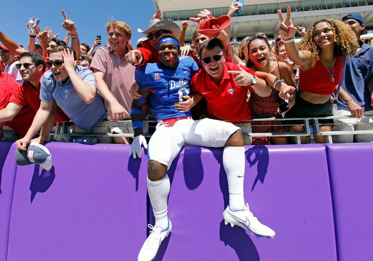 SMU safety Bryan Massey celebrates with fans in the stands after a NCAA football game at Amon G. Carter Stadium in Fort Worth, Texas, Saturday, Sept. 25, 2021. The SMU Mustangs defeated TCU Horned Frogs 42-34 to retain the Iron Skillet for another year.