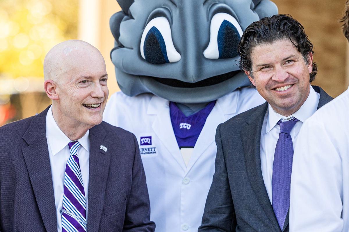 TCU Chancellor Victor Boschini Jr., left, and President Daniel Pullin prepare to cut the ribbon during the dedication of Arnold Hall, the newly opened home of the Burnett School of Medicine, in Fort Worth on Tuesday, Sept. 24, 2024.