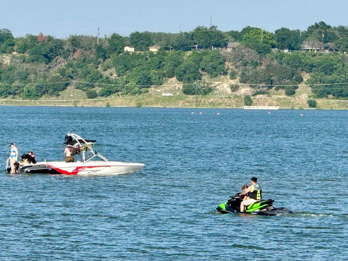 The view from Tavern on the Lake is a quiet scene with small boats and personal watercraft.
