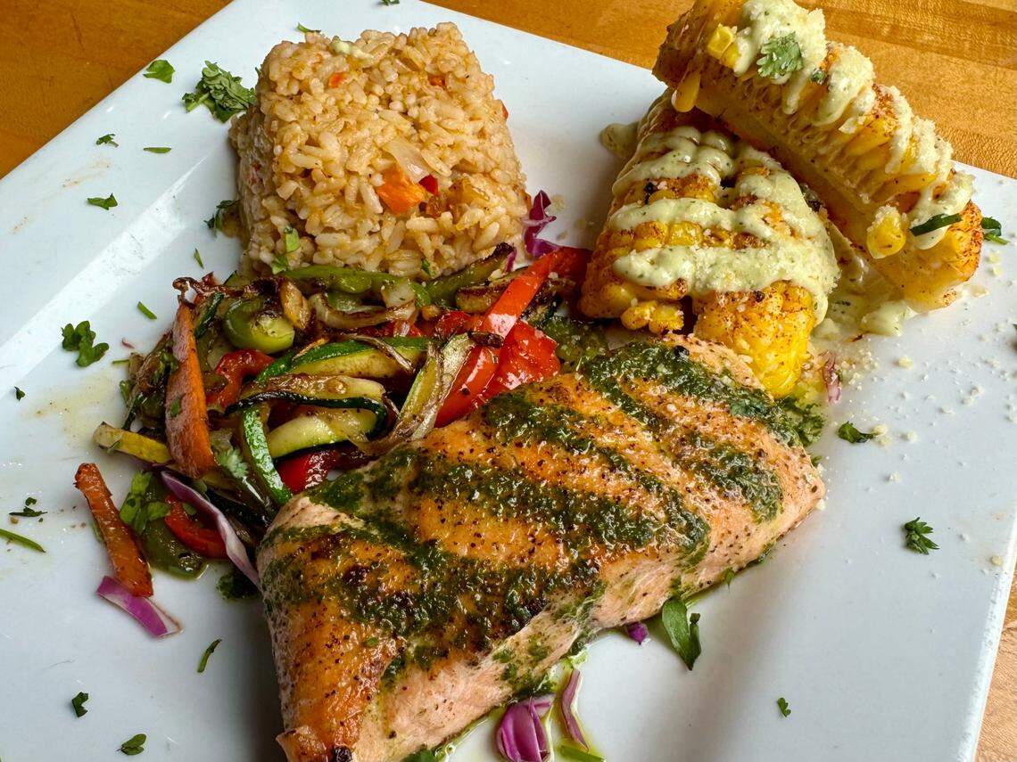 Grilled salmon with corn and Spanish rice at Tres Amigos Tacos and Tequila in Fort Worth.