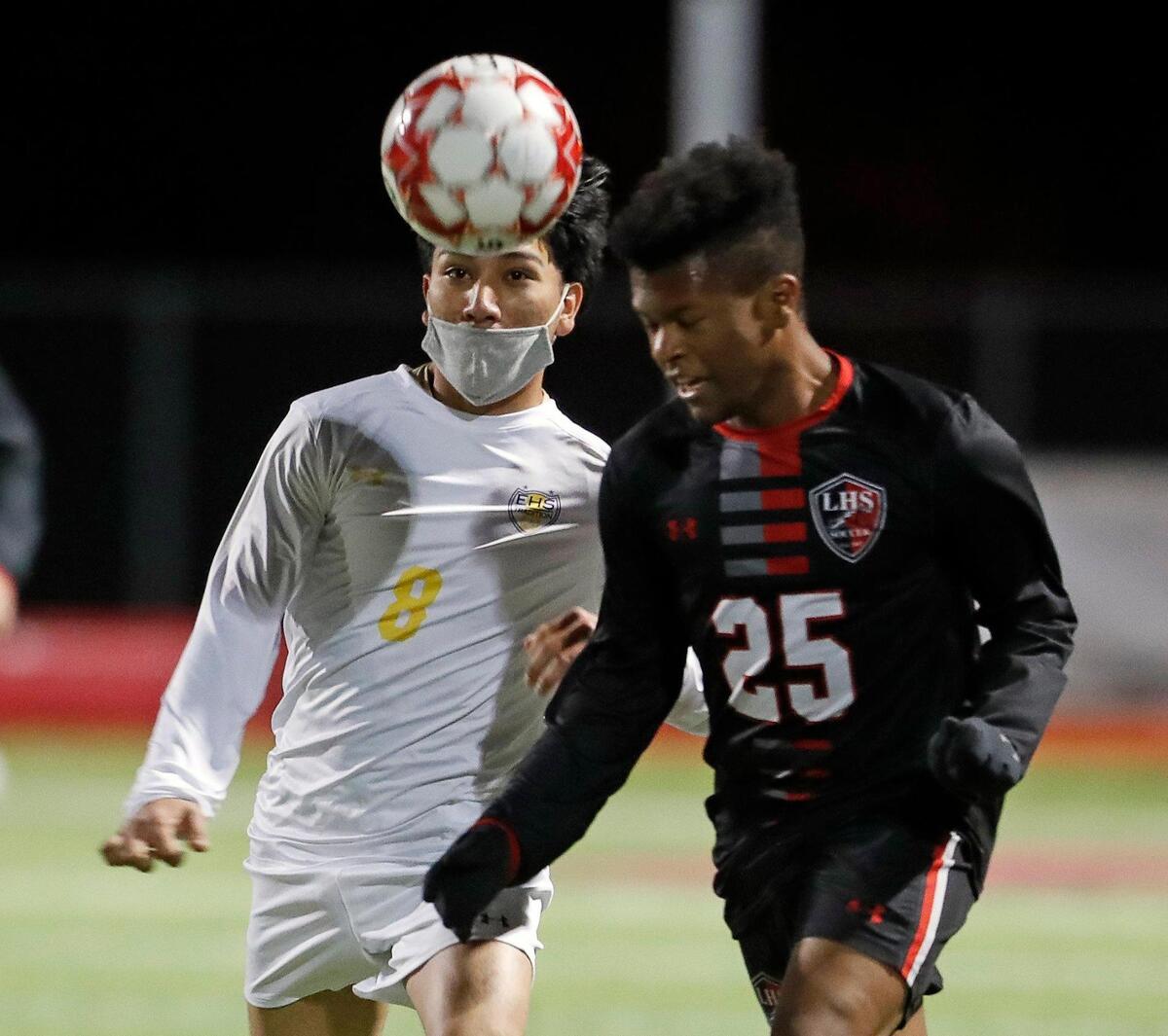 Legacy’s Joshua Omorodion (25) heads the ball in front of Everman’s Uriel Cervantes (8) during a district 8-5A high school soccer game at Mansfield Legacy High School in Mansfield, Texas, Wednesday, March 03, 2021. Legacy defeated Everman 5-1. (Special to the Star-Telegram Bob Booth)