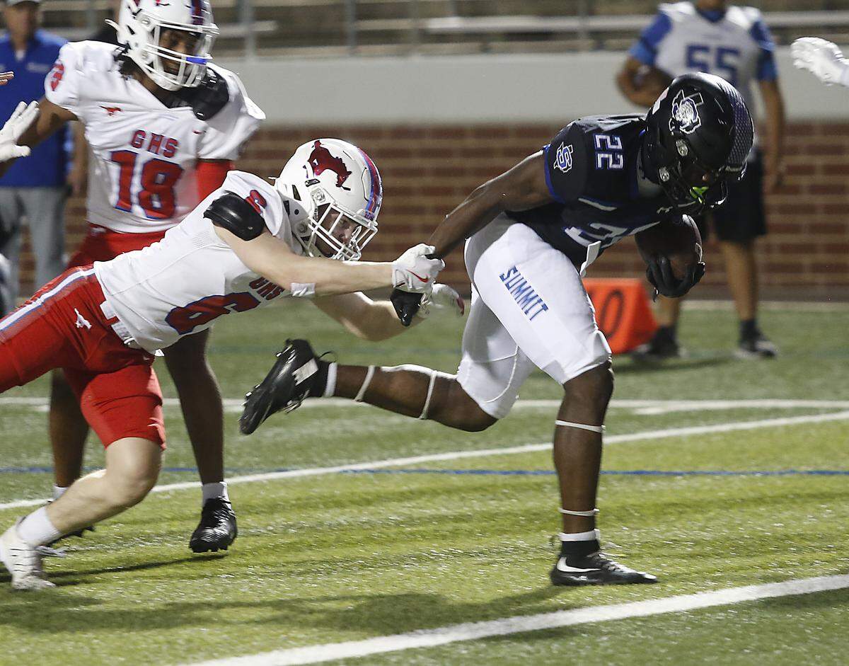 Summit’s Omogbolahan Daudu breaks a tackle for a touchdown against  Grapevine during their game at Newsom Stadium on Thursday, Sept. 25, 2025. 