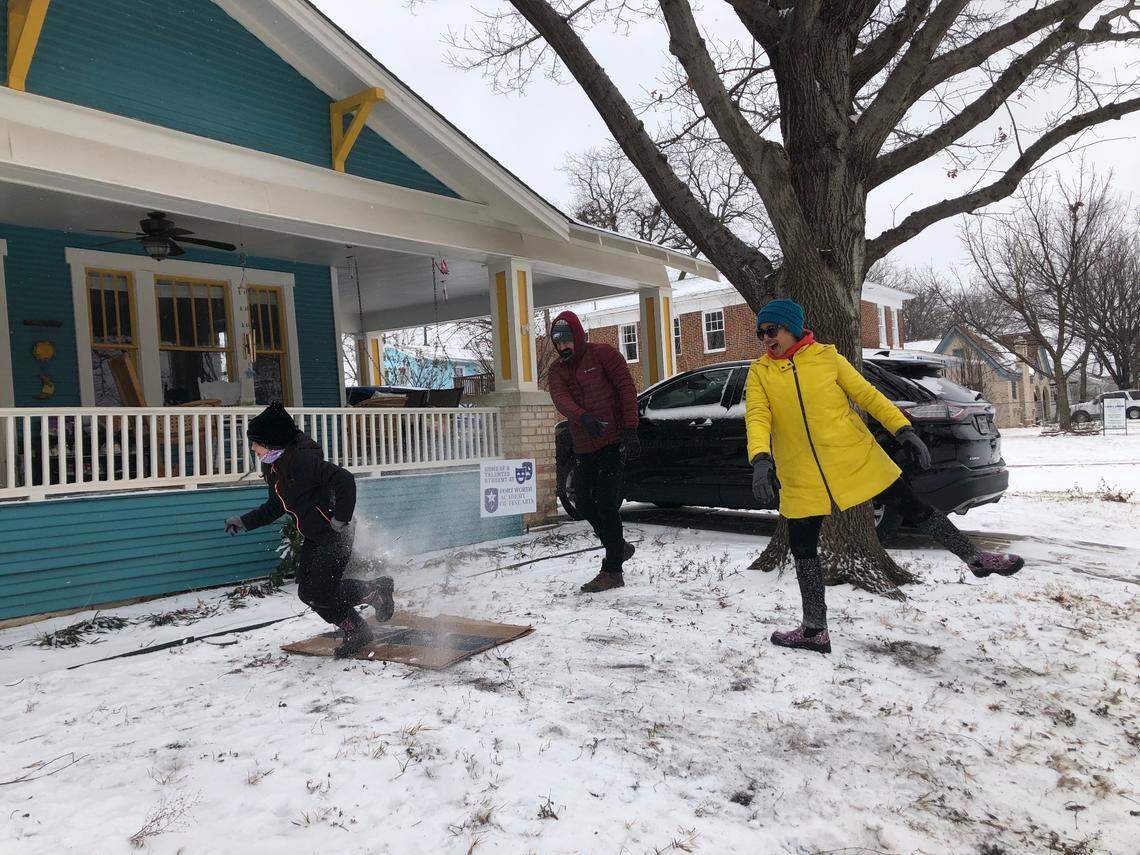 Sara Herrera and Tony Kopetchny toss snowballs at 8-year-old Lucia Kopetchny. Winter Storm Uri brought snow and freezing temperatures to North Texas on Feb. 14, 2021, but many families made the best of the unusual winter weather.