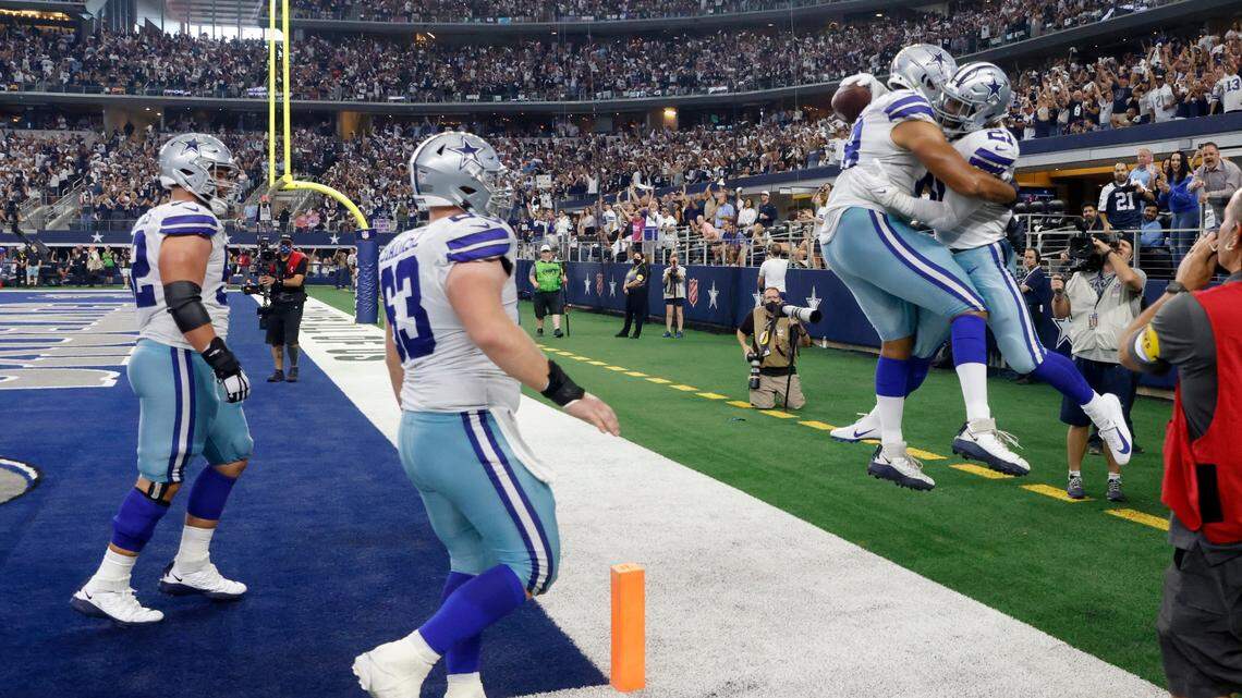 Dallas Cowboys guard Connor Williams, left, and Tyler Biadasz (63) watch as Matt Farniok, second from right, and Ezekiel Elliott (21) celebrate a touchdown run by Elliott in the second half of the Cowboys 44-20 win over the New York Giants on Sunday at AT&T Stadium.