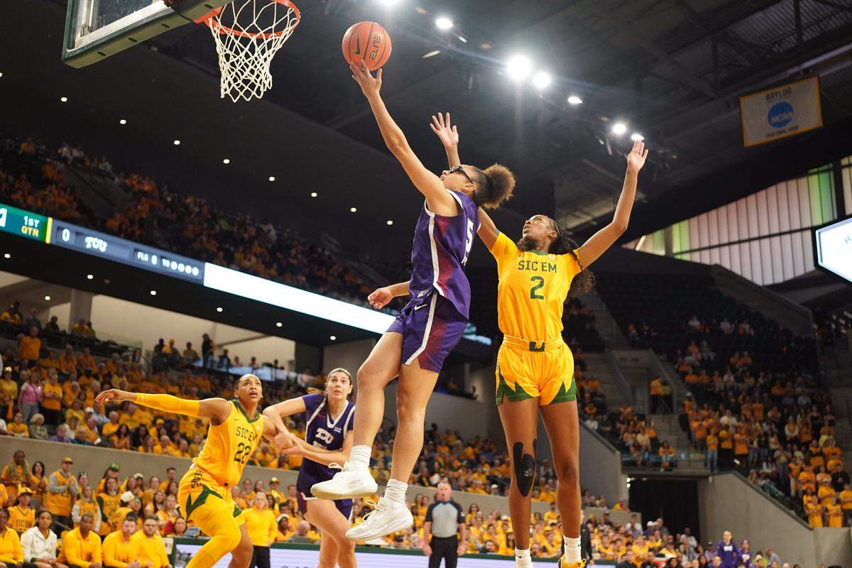 TCU guard Olivia Miles drives to the basket past Baylor forward Kiersten Johnson during the first half Thursday at Foster Pavilion in Waco.