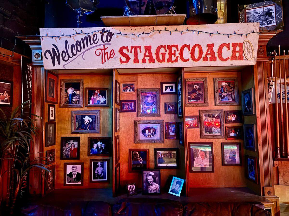 A wall adorned with photos of renowned country artists who have performed at the Stagecoach Ballroom.