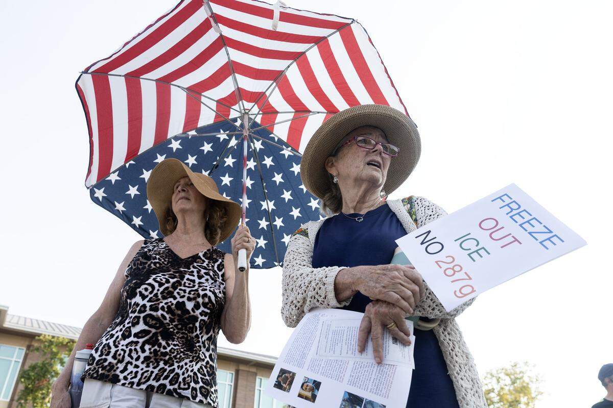 Keller residents Lisa Escaloni, left, and Judy Williams, right, protest with the group prior to the Keller City Council meeting at Keller Town Hall on Tuesday, Aug. 5, 2025. Protesters gathered to reject Item 287g on the Keller council meeting agenda is a resolution for the city to join forces with ICE.