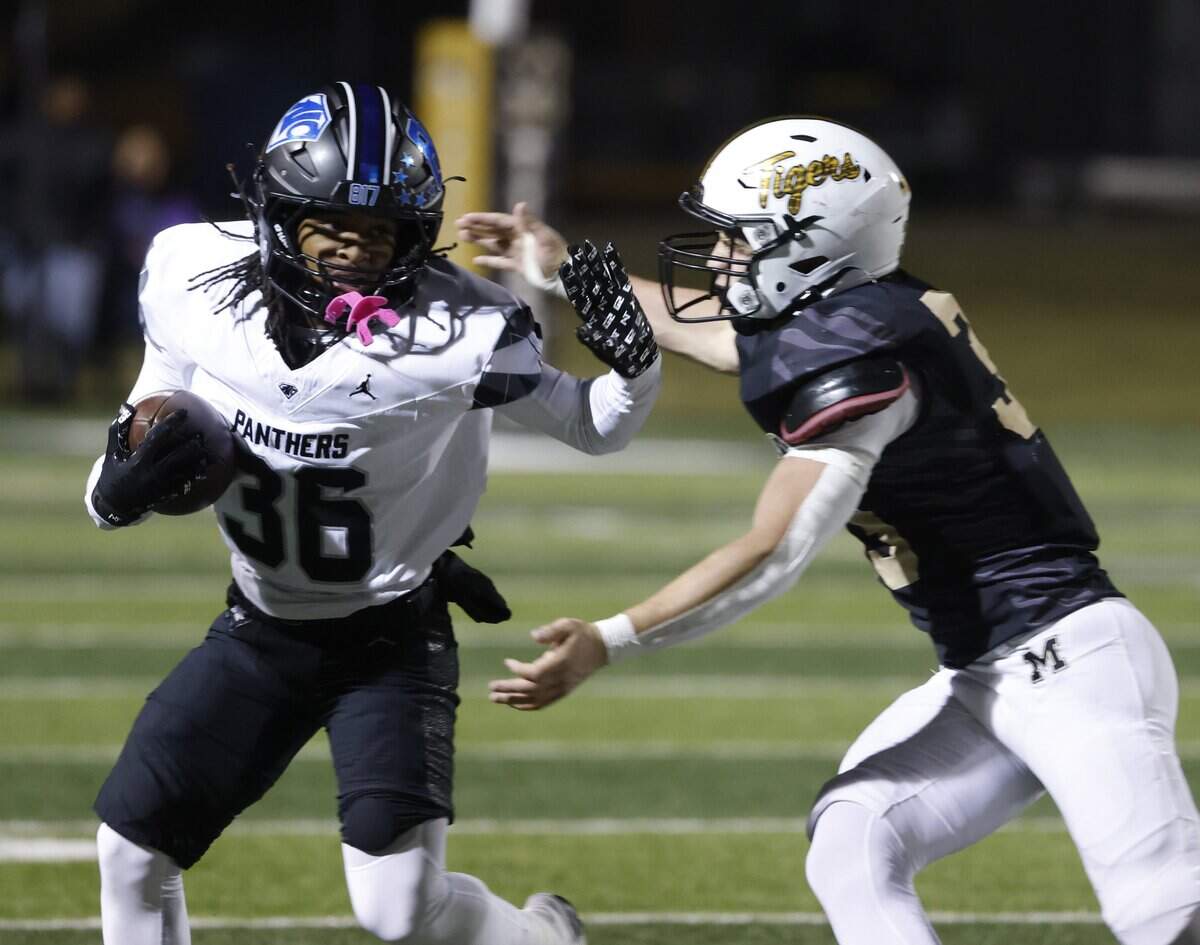 North Crowley running back Cam Russell (36) attempts to avoid a Tiger tackle in the backfield during the first half of a UIL football game between North Crowley and Mansfield at Vernon Newsom Stadium in Mansfield, Texas, Thursday, October, 30, 2025.