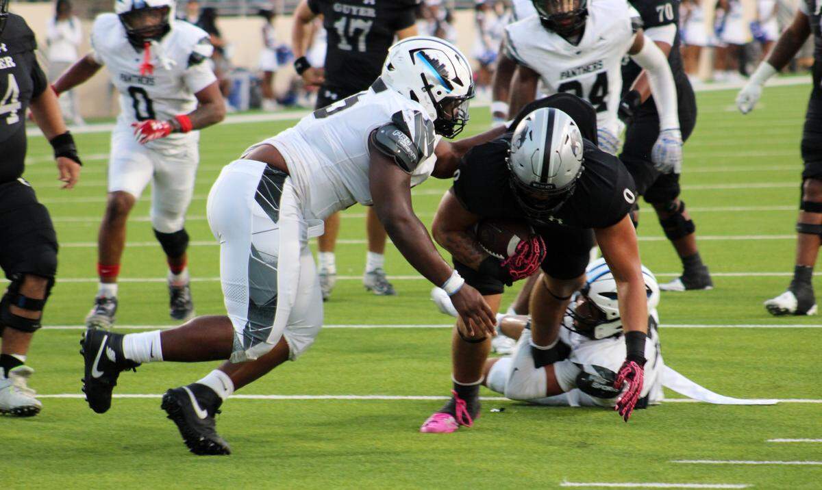 North Crowley defensive tackle Derrick Gleason, left, tackles Denton Guyer’s Zane Rowe in the first quarter of a UIL football Class 6A game at C.H. Collins Athletic Complex in Denton on Friday, Sept. 12, 2025.
