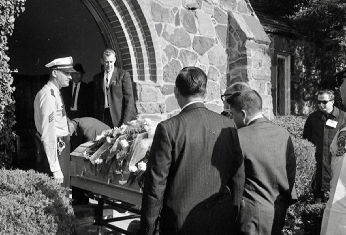 Pallbearers made up of newsmen and police bring out Lee Harvey Oswald’s casket from the chapel at Rose HIll Cemetery, Fort Worth, for burial on Nov. 25, 1963. KFJZ/1270 AM disc jockey Mark “Marky Baby” Stevens is at right.