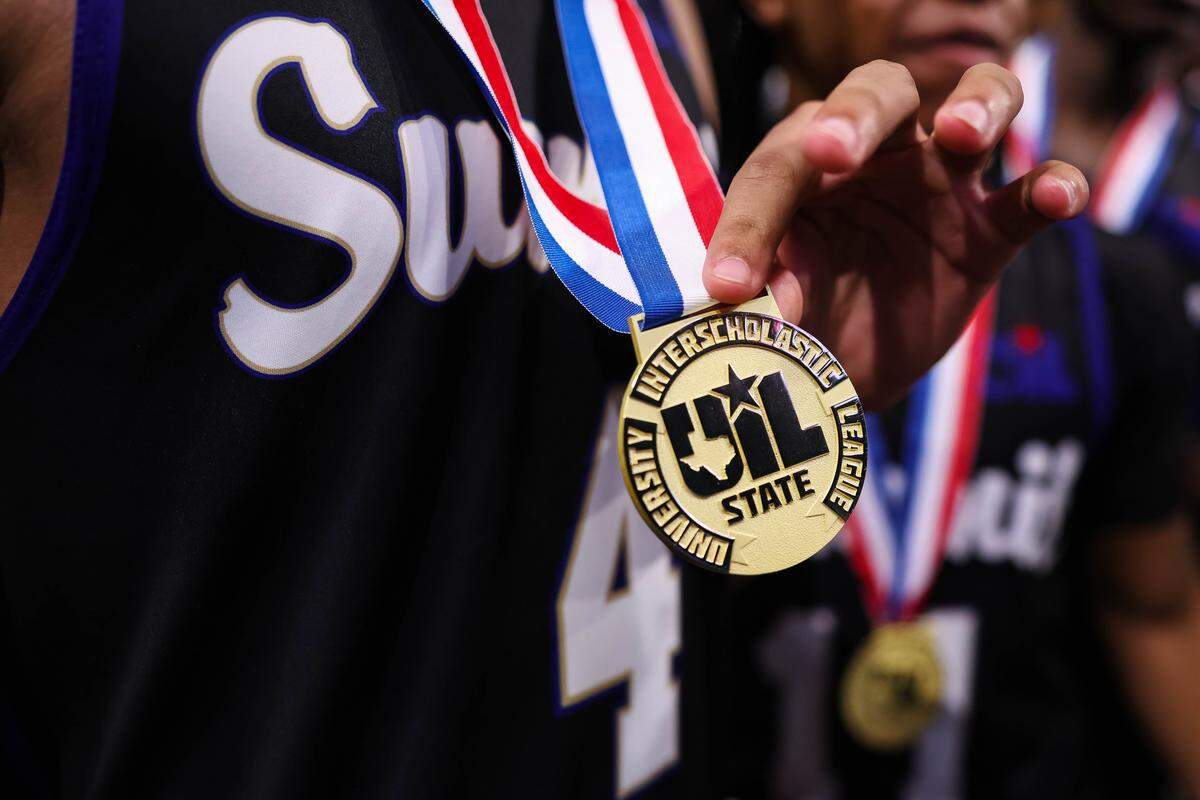 Mansfield Summit guard Jaxon Sneed holds his gold medal after the Class 5A Division II state championship game against Beaumont United on Saturday at the Alamodome in San Antonio.