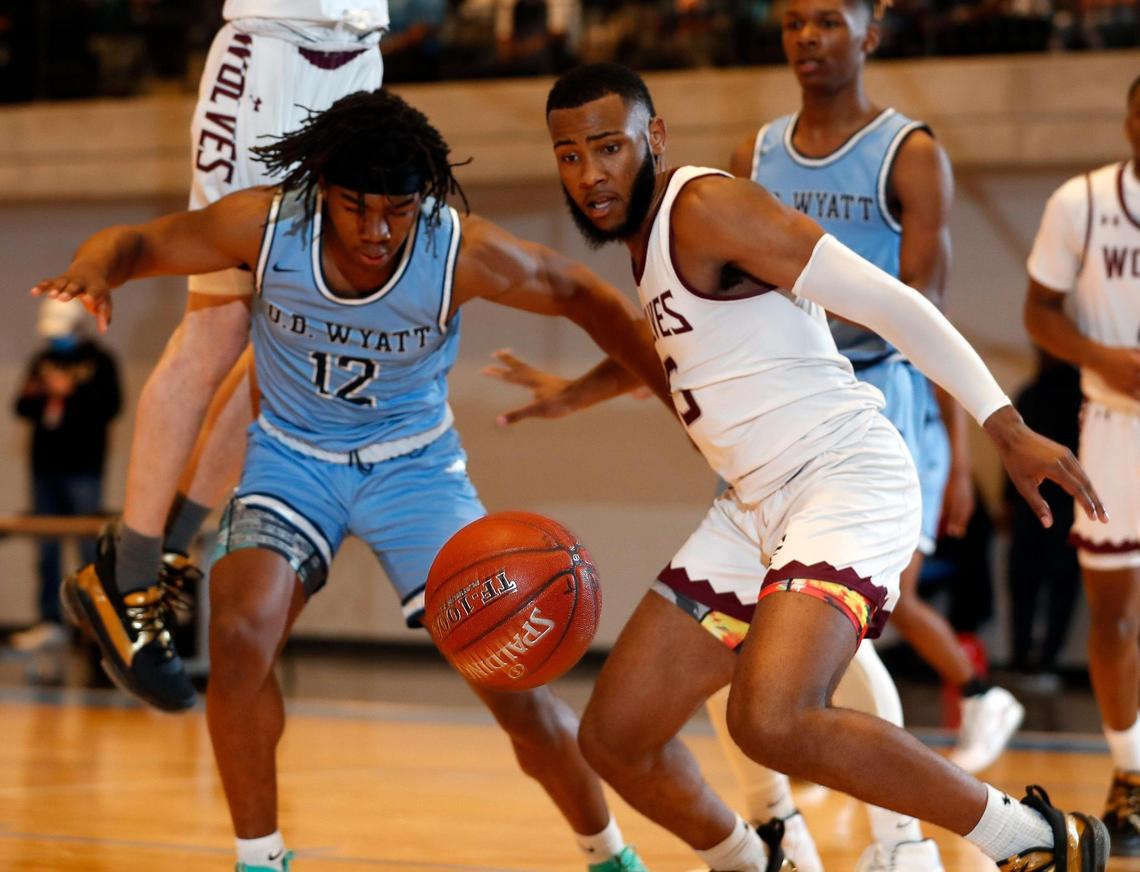 Wyatt guard Quest Madkins (12) and Timberview guard Jared Washington (5) go for a loose ball during the first half of a Division 5A Region 1 quarterfinal basketball game at Arlington ISD Athletics Complex in Arlington, Texas, Saturday, Feb. 27, 2021. O.D. Wyatt led at the half. (Special to the Star-Telegram Bob Booth)