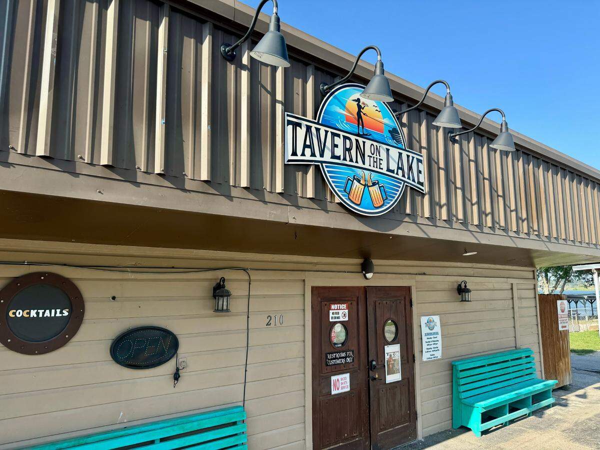 Front door of Tavern on the Lake, a single-story bar with the sign "Cocktails."