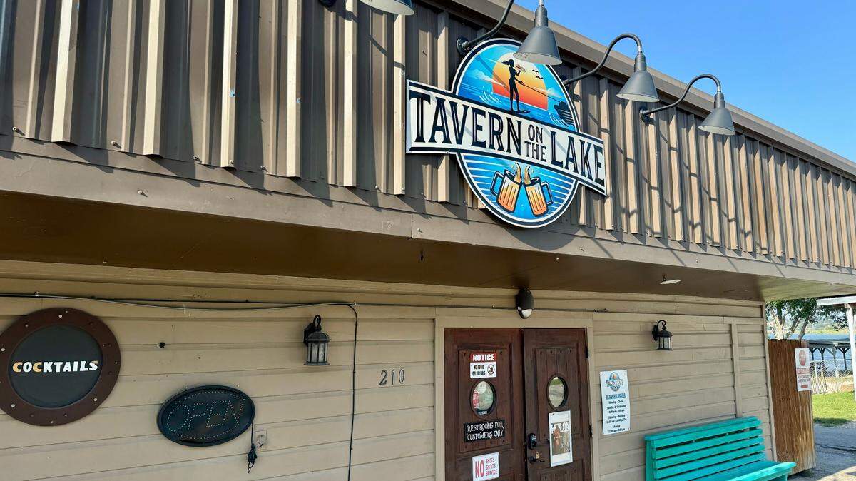 Front door of Tavern on the Lake, a single-story bar with the sign "Cocktails."