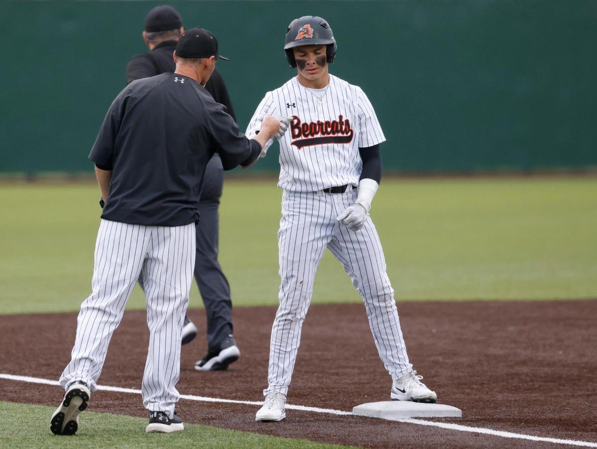 Aledo head coach Chad Barry fist bumps left fielder Luke Gladchuk (21) for his lead off triple during a UIL Area Round 5AD1 baseball playoff game at Bearcat Field in Aledo, Texas, Thursday, May 08, 2025.
