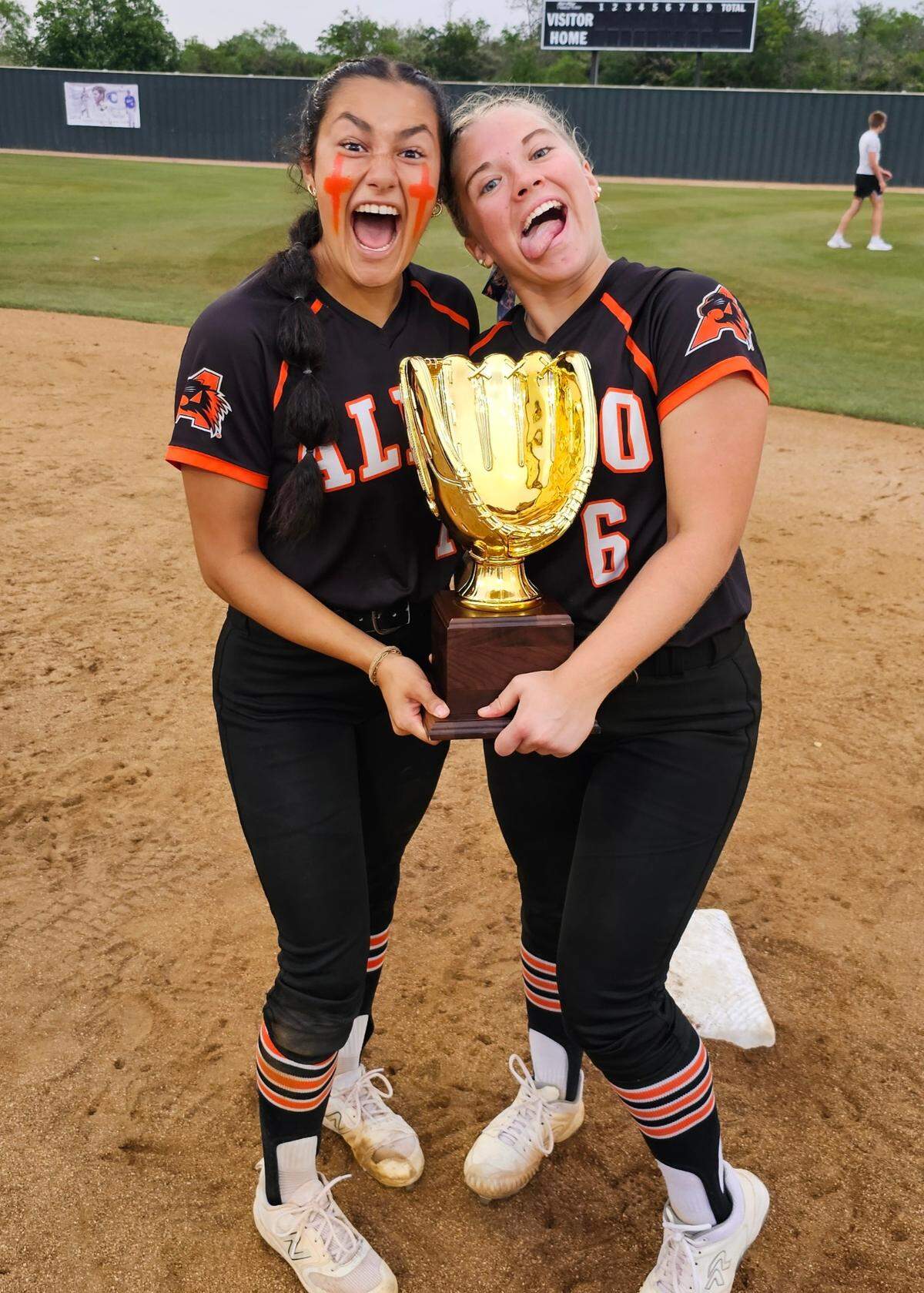 Aledo pitchers Brenlee Gonzales (left) and Taylor McKean (right) ham it up with the Class 5A Region I championship trophy after defeating Burleson Centennial 12-7 to sweep the series on Thursday, May 23, 2024 at Centennial High School in Burleson, Texas.