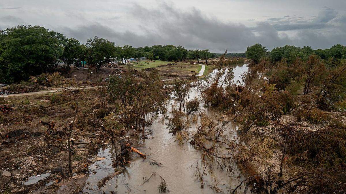 Debris fills the banks of the Guadalupe River on July 13, 2025, in Center Point after a storm dumped nearly 15 inches of rain, causing a 22-foot rise along the Guadalupe River.