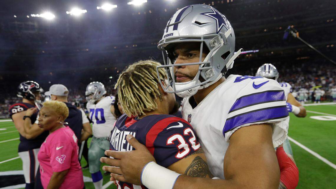 Houston Texans free safety Tyrann Mathieu (32) and Dallas Cowboys quarterback Dak Prescott (4) before an NFL football game, Sunday, Oct. 7, 2018, in Houston.