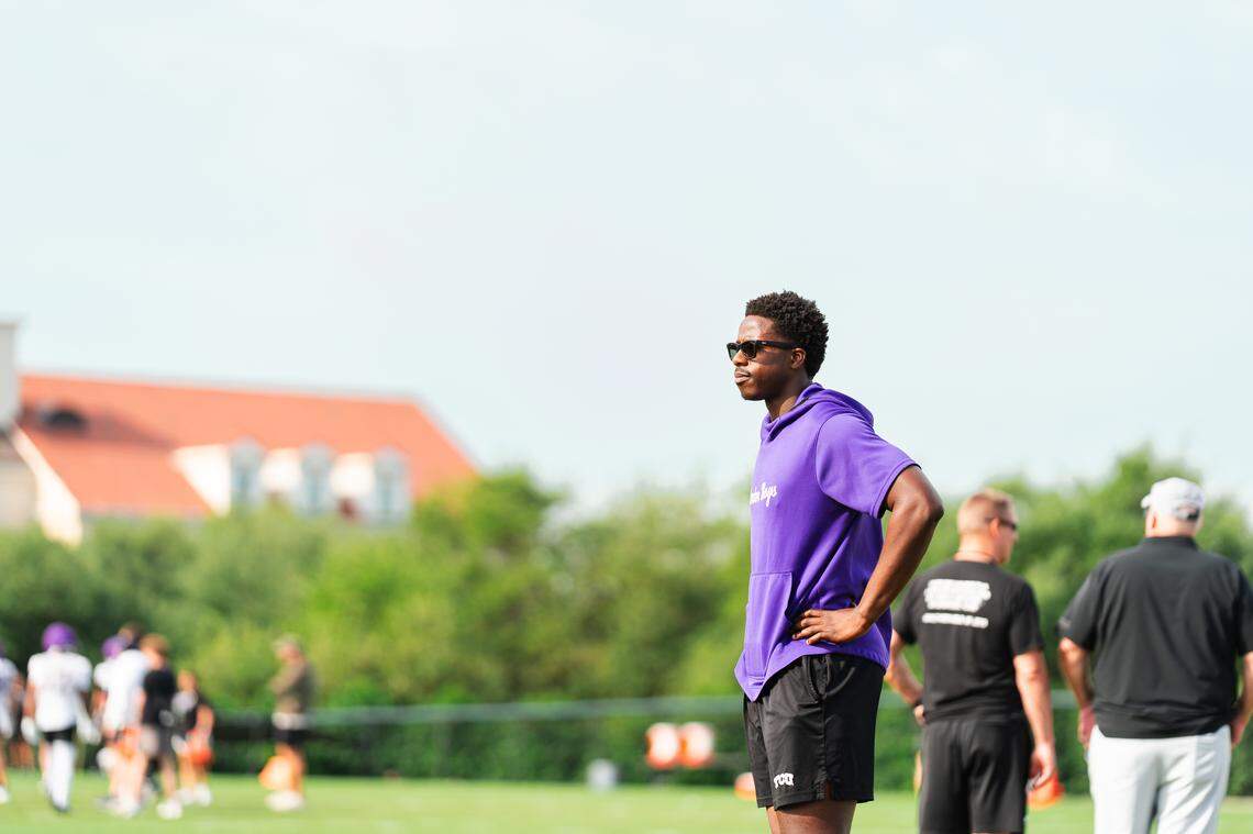 TCU player personnel graduate assistant Micheal Ibukun-Okeyode watches spring practice Thursday. Ibukun-Okeyode suffered a career-ending neck injury last August.