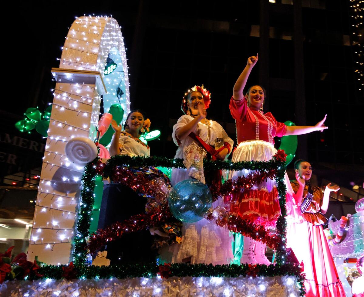 Members of Ballet Folklorico de Fort Worth wave to the crowd during the 2024 Parade of Lights.