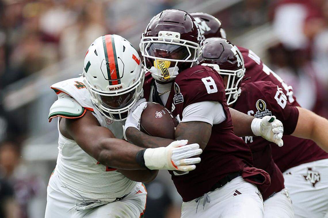 Miami Hurricanes defensive lineman Rueben Bain Jr. (left) wraps up Texas A&M running back Le'Veon Moss during a College Football Playoff game on Dec. 20, 2025, at Kyle Field in College Station, Texas.